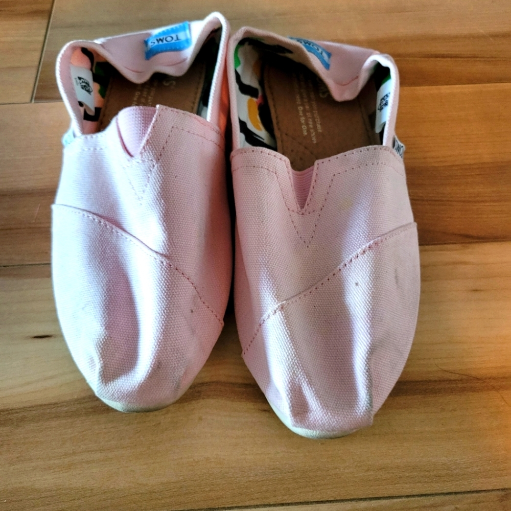 Well worn used women shoes. Toms